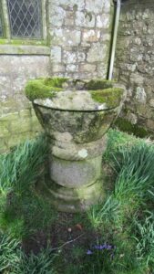 Historic pre-Norman font looking sadly neglected