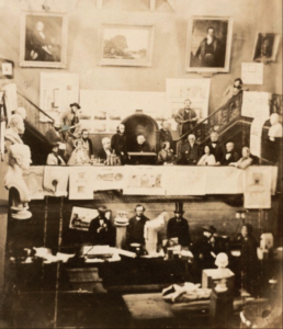 Polytechnic Hall 1859 - Sir Charles Lemon in the Chair, with the Fox sisters to the left