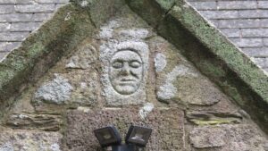 Strange face carved in stone above porch at Perranzabuloe Church